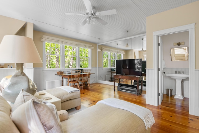 4 Shore Rd, Biddeford, ME 04005 - living area with wainscoting, wood-type flooring, a ceiling fan, and radiator