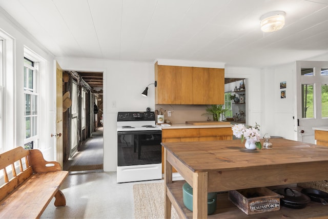 37 Walker Rd, Boothbay, ME 04537 - kitchen with electric range oven, brown cabinetry, and light countertops