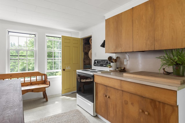 37 Walker Rd, Boothbay, ME 04537 - kitchen with range with electric cooktop, light countertops, and brown cabinetry