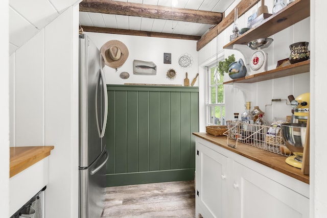 37 Walker Rd, Boothbay, ME 04537 - laundry area with light wood-type flooring and a wainscoted wall