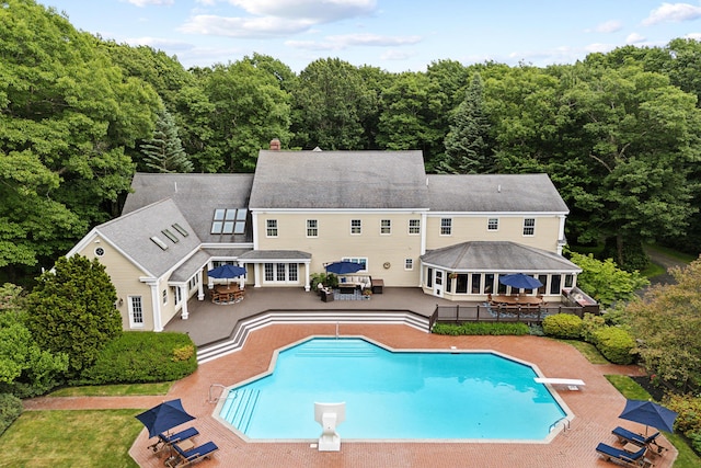 30 Plymouth Dr, Saco, ME 04072 - rear view of property with a patio area, a wooded view, outdoor dining area, and an outdoor pool