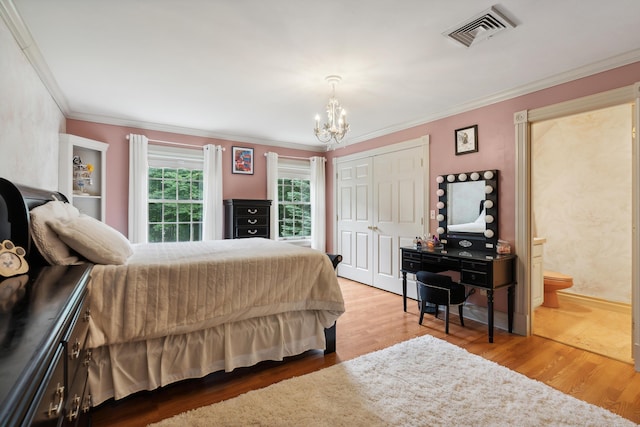 30 Plymouth Dr, Saco, ME 04072 - bedroom featuring a chandelier, wood finished floors, crown molding, ensuite bathroom, and a closet
