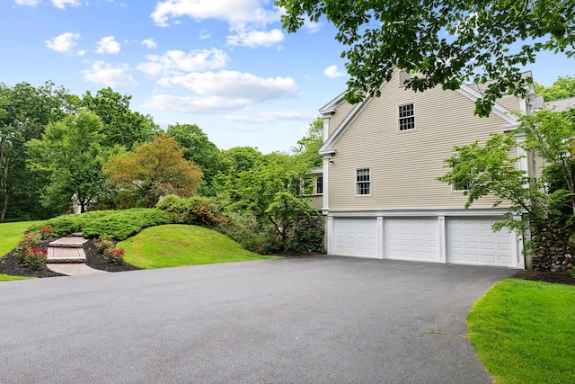 30 Plymouth Dr, Saco, ME 04072 - view of side of home with driveway, an attached garage, and a lawn