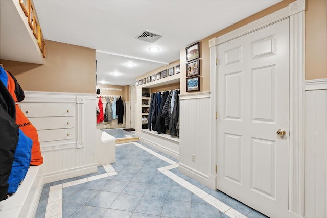30 Plymouth Dr, Saco, ME 04072 - mudroom featuring a wainscoted wall, tile patterned floors, inlaid floor details, and a decorative wall