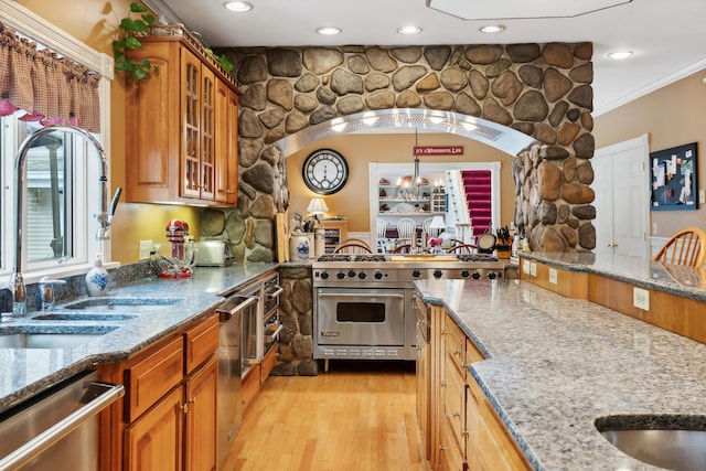 30 Plymouth Dr, Saco, ME 04072 - kitchen with appliances with stainless steel finishes, a sink, light stone countertops, light wood-type flooring, and glass insert cabinets