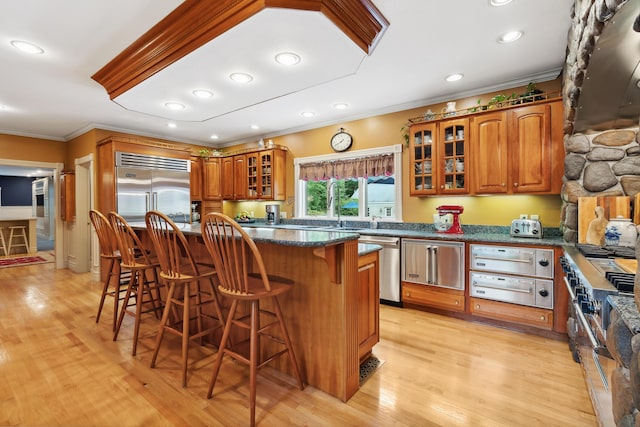 30 Plymouth Dr, Saco, ME 04072 - kitchen with crown molding, stainless steel appliances, a warming drawer, a kitchen breakfast bar, and brown cabinets