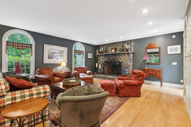 30 Plymouth Dr, Saco, ME 04072 - living room featuring healthy amount of natural light, a stone fireplace, light wood-style floors, recessed lighting, and baseboards