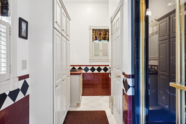 30 Plymouth Dr, Saco, ME 04072 - hallway featuring light tile patterned flooring, a wainscoted wall, and tile walls
