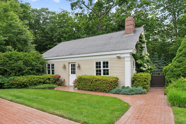 30 Plymouth Dr, Saco, ME 04072 - cape cod-style house featuring a chimney, a front lawn, a shingled roof, and an outbuilding