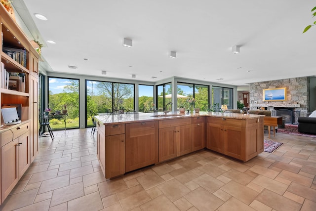 72 Vine St, South Berwick, ME 03908 - kitchen featuring open floor plan, a sink, plenty of natural light, and a stone fireplace