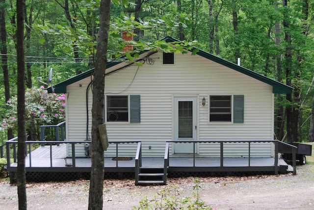 16 Evergreen Estates Rd, Nobleboro, ME 04555 - view of front facade with a deck and a wooded view