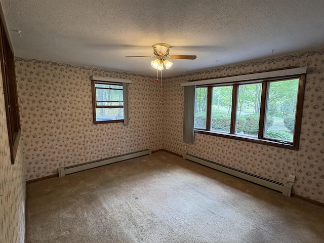 16 Evergreen Estates Rd, Nobleboro, ME 04555 - unfurnished room featuring baseboard heating, wallpapered walls, carpet flooring, ceiling fan, and a textured ceiling