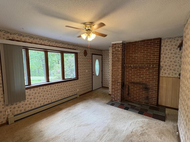 16 Evergreen Estates Rd, Nobleboro, ME 04555 - unfurnished living room featuring a baseboard heating unit, wallpapered walls, ceiling fan, carpet, and a textured ceiling