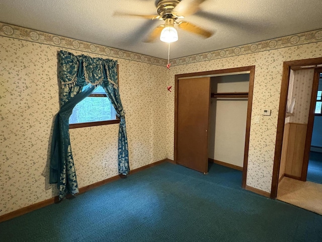16 Evergreen Estates Rd, Nobleboro, ME 04555 - unfurnished bedroom featuring carpet, a textured ceiling, wallpapered walls, ceiling fan, and a closet