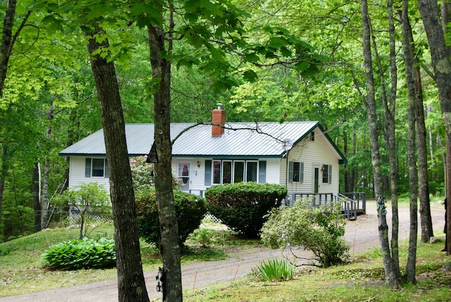 16 Evergreen Estates Rd, Nobleboro, ME 04555 - ranch-style house with a chimney, driveway, a metal roof, and a wooded view