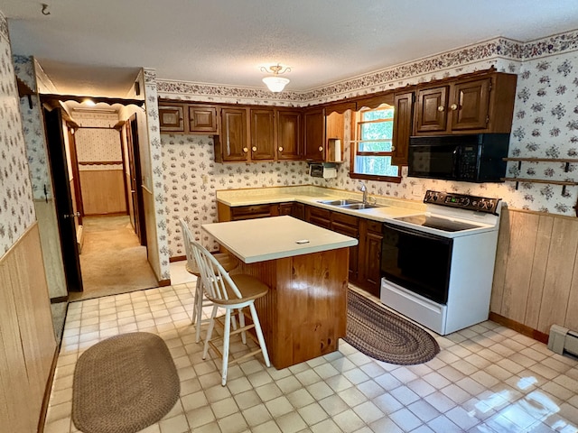 16 Evergreen Estates Rd, Nobleboro, ME 04555 - kitchen featuring white electric range oven, black microwave, wallpapered walls, a kitchen island, and a wainscoted wall