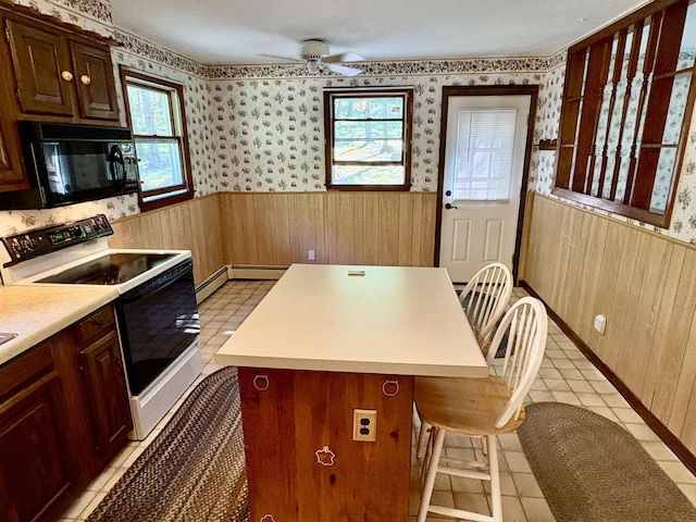 16 Evergreen Estates Rd, Nobleboro, ME 04555 - kitchen featuring electric stove, black microwave, wainscoting, healthy amount of natural light, and wallpapered walls