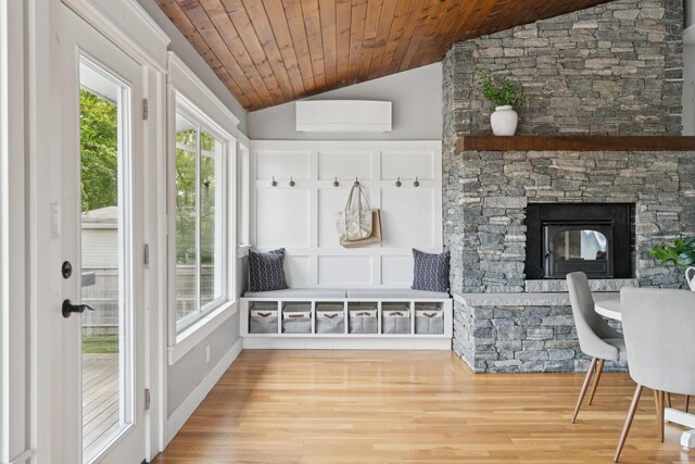 217 Ocean Ave, Portland, ME 04103 - mudroom with lofted ceiling, wood finished floors, wooden ceiling, a wall unit AC, and a fireplace