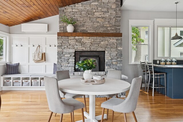 217 Ocean Ave, Portland, ME 04103 - dining space featuring a wall unit AC, wood finished floors, lofted ceiling, healthy amount of natural light, and wood ceiling