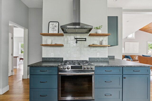217 Ocean Ave, Portland, ME 04103 - kitchen featuring stainless steel range with gas stovetop, open shelves, wall chimney range hood, wood finished floors, and dark countertops
