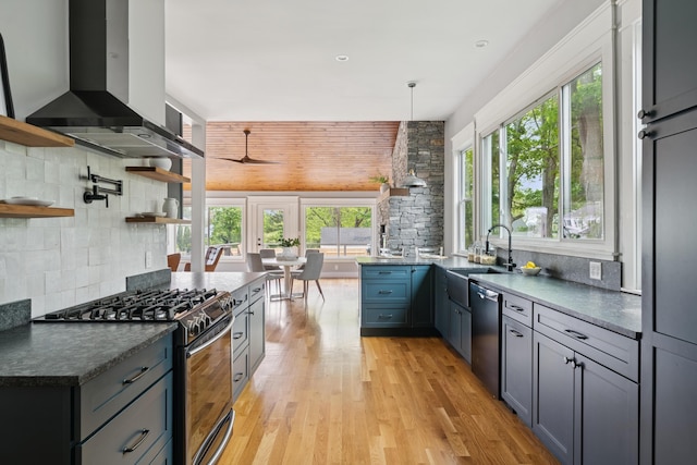 217 Ocean Ave, Portland, ME 04103 - kitchen featuring appliances with stainless steel finishes, wall chimney exhaust hood, a sink, and plenty of natural light