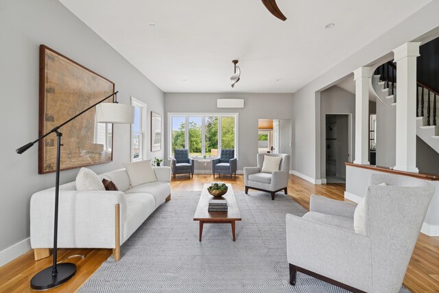 217 Ocean Ave, Portland, ME 04103 - living room featuring decorative columns, stairs, wood finished floors, and baseboards