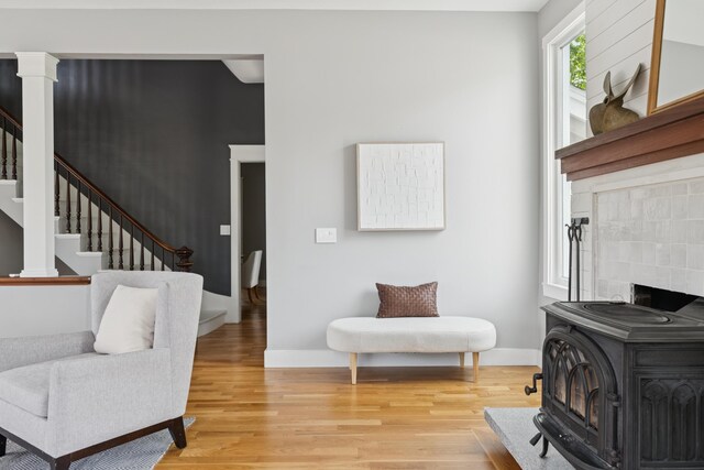 217 Ocean Ave, Portland, ME 04103 - living area with a wood stove, light wood finished floors, stairs, and baseboards