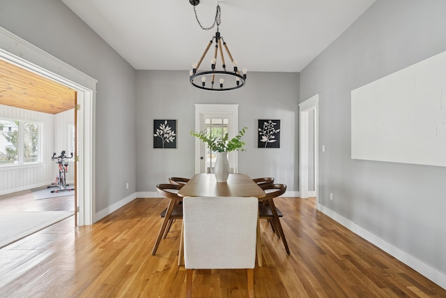 217 Ocean Ave, Portland, ME 04103 - dining space featuring a chandelier, light wood finished floors, and baseboards
