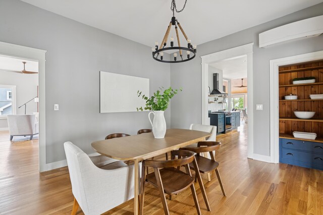217 Ocean Ave, Portland, ME 04103 - dining space featuring light wood-type flooring, baseboards, and a chandelier