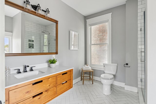 217 Ocean Ave, Portland, ME 04103 - bathroom with toilet, vanity, a tile shower, and healthy amount of natural light