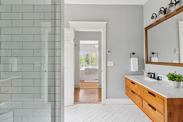 217 Ocean Ave, Portland, ME 04103 - ensuite bathroom featuring vanity, tiled shower, and baseboards