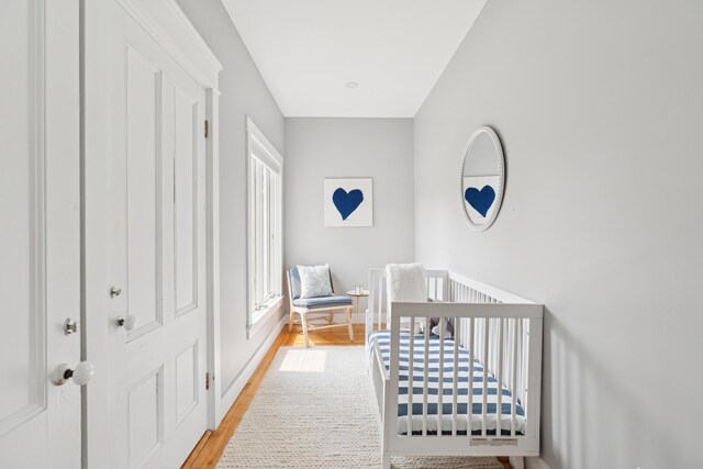 217 Ocean Ave, Portland, ME 04103 - bedroom featuring wood finished floors and a crib