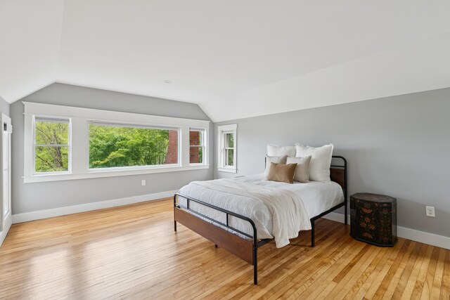 217 Ocean Ave, Portland, ME 04103 - bedroom with vaulted ceiling, wood-type flooring, and baseboards
