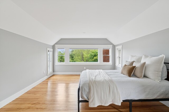 217 Ocean Ave, Portland, ME 04103 - bedroom with lofted ceiling, baseboards, and light wood-style floors