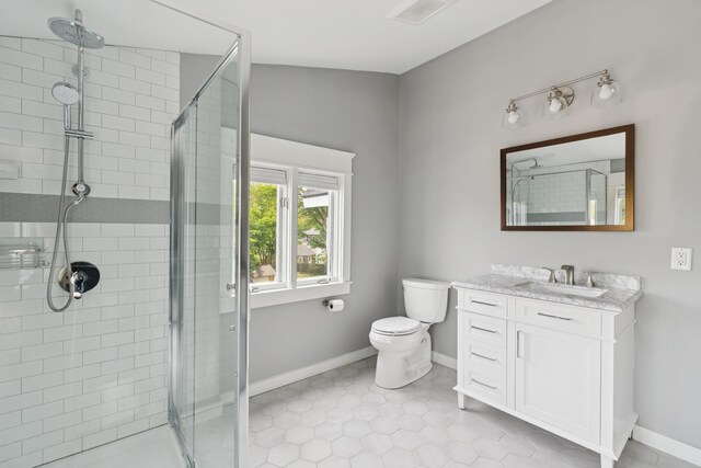 217 Ocean Ave, Portland, ME 04103 - bathroom featuring a shower stall, baseboards, vanity, and toilet