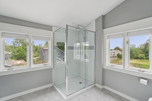 217 Ocean Ave, Portland, ME 04103 - full bathroom featuring plenty of natural light, a stall shower, vaulted ceiling, and baseboards