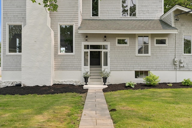 217 Ocean Ave, Portland, ME 04103 - property entrance with a yard and a shingled roof