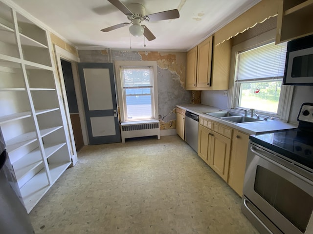 147 Spring St, Westbrook, ME 04092 - kitchen with stainless steel appliances, radiator heating unit, a sink, light countertops, and a ceiling fan
