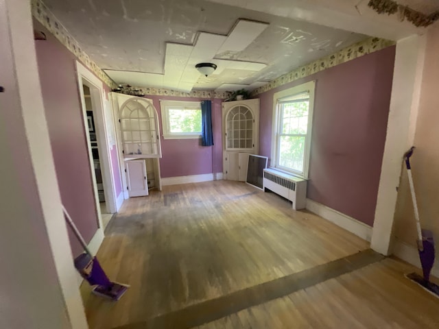 147 Spring St, Westbrook, ME 04092 - corridor with radiator, baseboards, and wood finished floors