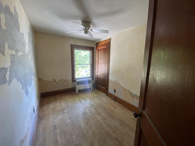 147 Spring St, Westbrook, ME 04092 - unfurnished room featuring radiator, baseboards, wood finished floors, and a ceiling fan