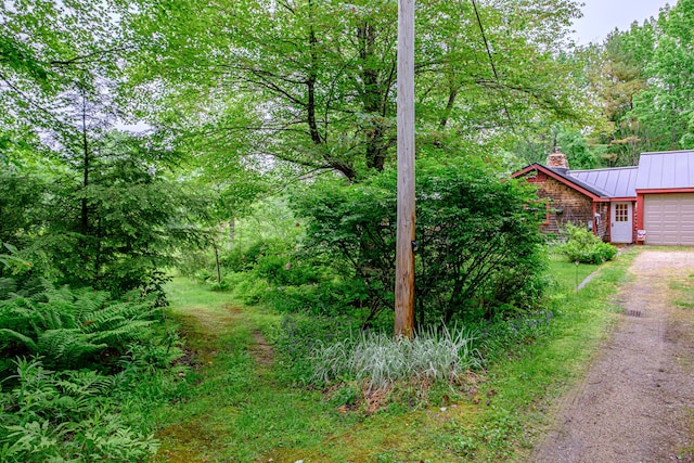 115 Wards Hill Rd, Baldwin, ME 04091 - view of yard featuring an attached garage and dirt driveway