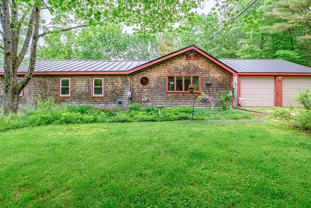 115 Wards Hill Rd, Baldwin, ME 04091 - view of front facade featuring a front lawn, a metal roof, an attached garage, and a standing seam roof