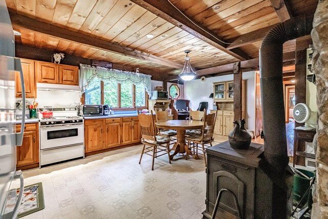 115 Wards Hill Rd, Baldwin, ME 04091 - kitchen with white gas range, a wooden ceiling with exposed beams, under cabinet range hood, a wood stove, and light countertops