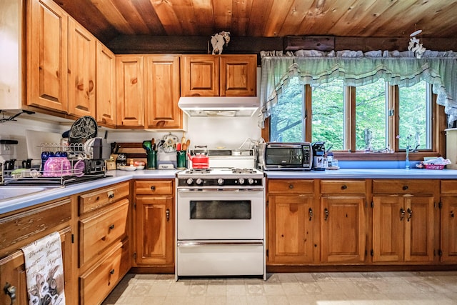 115 Wards Hill Rd, Baldwin, ME 04091 - kitchen featuring under cabinet range hood, white gas range, light countertops, wooden ceiling, and brown cabinetry