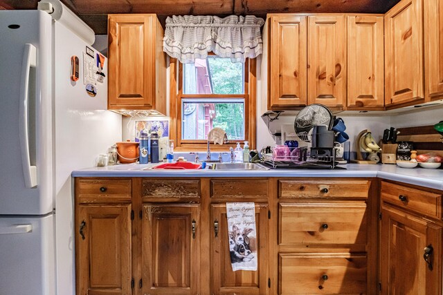 115 Wards Hill Rd, Baldwin, ME 04091 - kitchen with freestanding refrigerator, light countertops, and brown cabinets
