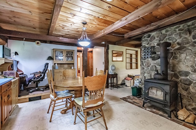 115 Wards Hill Rd, Baldwin, ME 04091 - dining space with a wood ceiling with exposed beams, a wood stove, and light floors