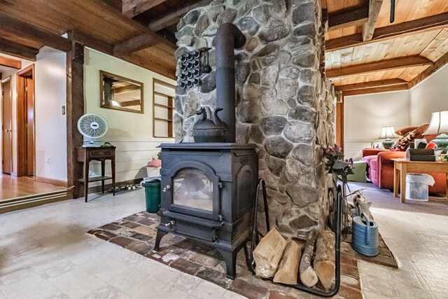 115 Wards Hill Rd, Baldwin, ME 04091 - living room featuring a wooden ceiling with exposed beams, a wood stove, and wainscoting