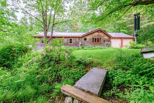 115 Wards Hill Rd, Baldwin, ME 04091 - single story home with a metal roof, a front lawn, a garage, and a standing seam roof