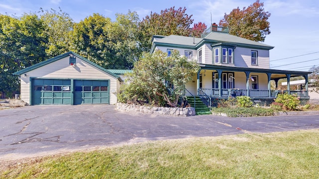 143 Union Ave, Old Orchard Beach, ME 04064 - view of front facade with covered porch, a front yard, driveway, a chimney, and an attached garage