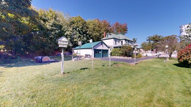 143 Union Ave, Old Orchard Beach, ME 04064 - view of grassy yard with a garage and asphalt driveway